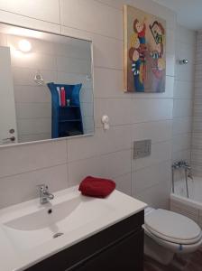 a bathroom with a sink and a toilet and a mirror at NEW! Great Location! Vibrant Downtown, Talpiot Market, Flea Market, Carmel Beach, close to everywhere in Haifa