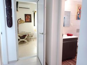 a bathroom with a door leading to a kitchen at NEW! Great Location! Vibrant Downtown, Talpiot Market, Flea Market, Carmel Beach, close to everywhere in Haifa