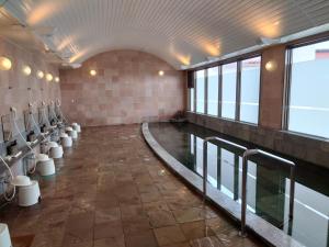 a bathroom with a row of toilets in a room at Ishigaki Seaside Hotel in Ishigaki Island