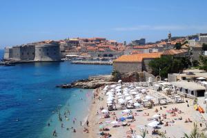 a group of people on a beach in the water at Apartments with WiFi Dubrovnik - 8590 in Dubrovnik