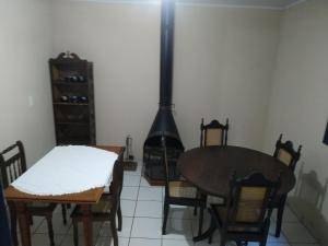 a dining room with a table and a fireplace at Pousada do guariba in Santa Teresa +13 photos