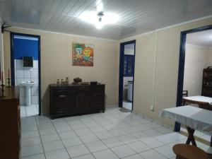 a living room with a sink and a bathroom at Pousada do guariba in Santa Teresa