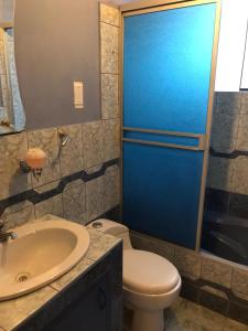 a bathroom with a toilet and a sink at Departamentos Camino Real incluye garaje in Cusco