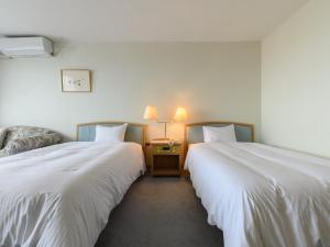 Postel nebo postele na pokoji v ubytování Tabist Katahara Resort Gamagori