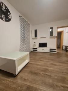 a living room with a white table and a tv at Paula Haus Trier in Trier