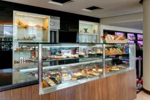 a bakery display case with many different types of pastries at AZIMUT Hotel Olympic Moscow in Moscow