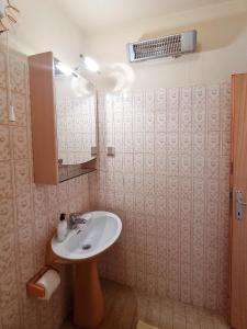 a bathroom with a sink and a mirror at Triple Room Vrboska 540e in Vrboska