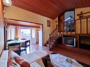 a living room with a couch and a tv and a table at Apartments and rooms by the sea Vrboska (Hvar) - 540 in Vrboska