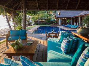a patio with blue furniture and a swimming pool at Villa Waimarie - SHA Extra Plus in Lipa Noi