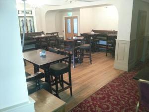 a dining room with wooden tables and chairs at Murphys Hotel in Tinahely