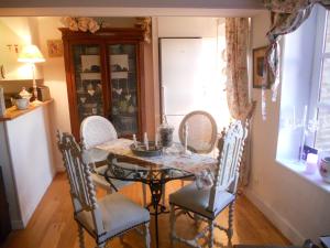 a dining room with a table and chairs and a window at chambre d'hotes le nid du phare avec jacuzzi in Honfleur +49 photos
