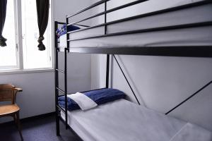 a bedroom with two bunk beds in a room at Maze Backpackers - Sydney in Sydney