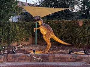 a statue of a dog holding an umbrella at Gorgeous Henderson Home with Pool! in Las Vegas