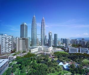 an aerial view of a city with tall buildings at Traders Hotel, Kuala Lumpur in Kuala Lumpur