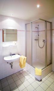 a bathroom with a shower and a sink at Hotel Am Quellberg in Recklinghausen +19 photos