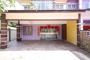 a house with a gate in front of it at OYO Homes 90575 CK Bahau Homestay in Bahau