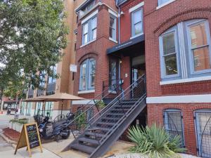 a brick building with a staircase in front of it at U Street Capsule Hostel in Washington