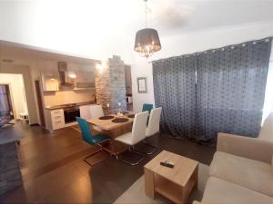 a dining room and living room with a table and chairs at Apartments with parking space Sumartin, Brac - 11926 in Sumartin