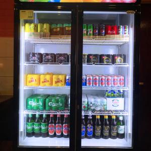 a refrigerator filled with lots of soda and sodas at AE Semporna Guesthouse 极潜旅店 in Semporna