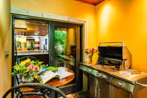 a kitchen with a table with flowers on it at La Esquina (3 minutes from Beach, perfect for a family getaway) in Tamarindo