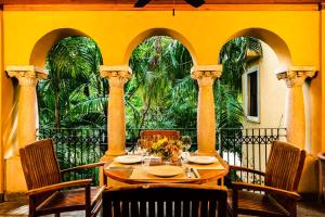 a table on a balcony with a table and chairs at La Esquina (3 minutes from Beach, perfect for a family getaway) in Tamarindo +28 photos