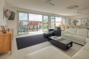 a living room with a couch and a table at Villa Moyne in Port Fairy