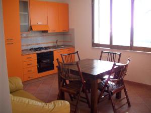 a kitchen with a wooden table and four chairs at Kalypso in Sciacca