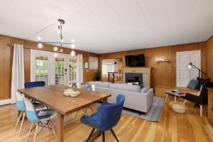 een woonkamer met een tafel en blauwe stoelen bij Gorgeous 7BDR 16 Guests Perfect For Your Family in Nanaimo