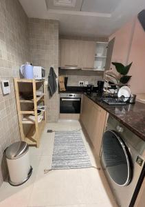 a kitchen with a sink and a dishwasher at Ansam, Yas Island in Abu Dhabi