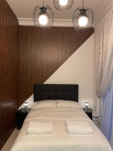a bedroom with a large bed with two white pillows at Ansam, Yas Island in Abu Dhabi