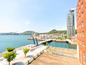 a view of a body of water next to a building at Premier Hotel Mojiko in Kitakyushu