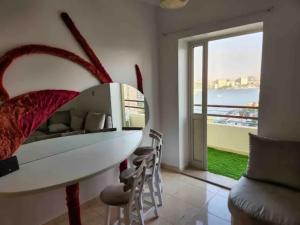 a dining room with a table and a large window at (AB By The River) 2BR 901 With Great View in Cairo