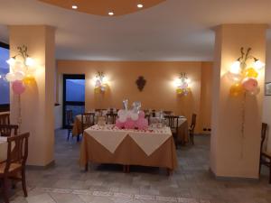 a dining room with a table with a cake on it at Hotel Brufa in Monteleone di Spoleto