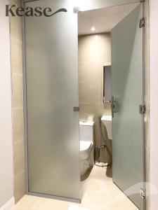 uma casa de banho com um WC e uma porta de vidro deslizante em Kease Malqa A-6 Royal Touch XZ56 em Riyadh