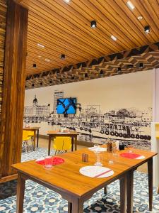 a dining room with a table and a drawing on the wall at Ginger Mumbai, Goregaon in Mumbai