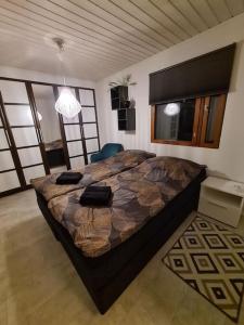1 dormitorio con 1 cama grande en una habitación con ventanas en Villa Onia - sauna, palju ja iso yksityinen piha, en Lappers