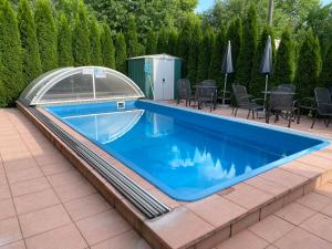 a swimming pool with a cover on a patio at Apartmán Sophia 2 in Velké Losiny