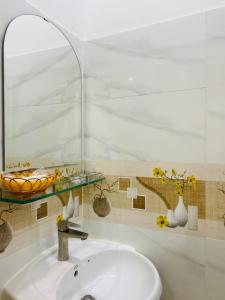 a bathroom sink with a glass shelf above it at Nhà nghỉ 126 in Can Tho