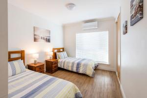 a bedroom with two beds and a window at Riverview Apartments 2 3 Building 2 Unit 3 in Iluka