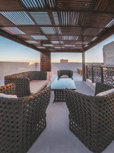 a patio with chairs and a couch and a table at Riad Dar Al Rumman in Qurayyah