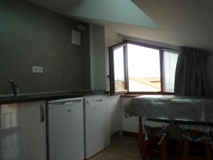 a kitchen with a sink and a window and a counter at LOS ATICOS in Santander