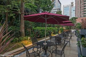 a row of tables and chairs under an umbrella at Shenzhen FY Hotel in Shenzhen