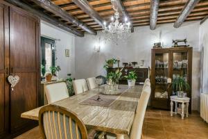 a dining room with a wooden table and chairs at El paller in Borrassá