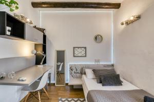 a bedroom with a bed and a desk in a room at El paller in Borrassá