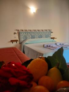 a bedroom with a bed and a bowl of fruit at Agriturismo i doni del mandorlo in Alghero