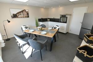 a kitchen and dining room with a table and chairs at Gästehaus Achenbach in Biedenkopf
