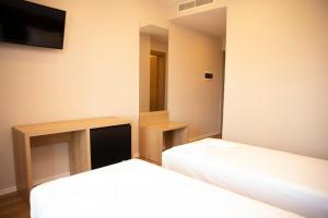 Postel nebo postele na pokoji v ubytování Hotel Continental