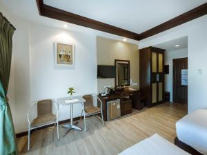 a living room with a table and chairs at Royal Nakhara Hotel and Convention Centre in Nong Khai