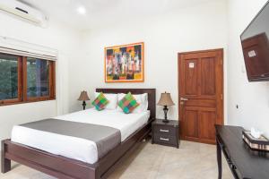 a bedroom with a bed and a wooden door at Villa Yati in Seminyak +21 photos