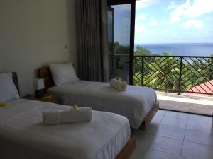 Postel nebo postele na pokoji v ubytování Bougainvillas Seychelles